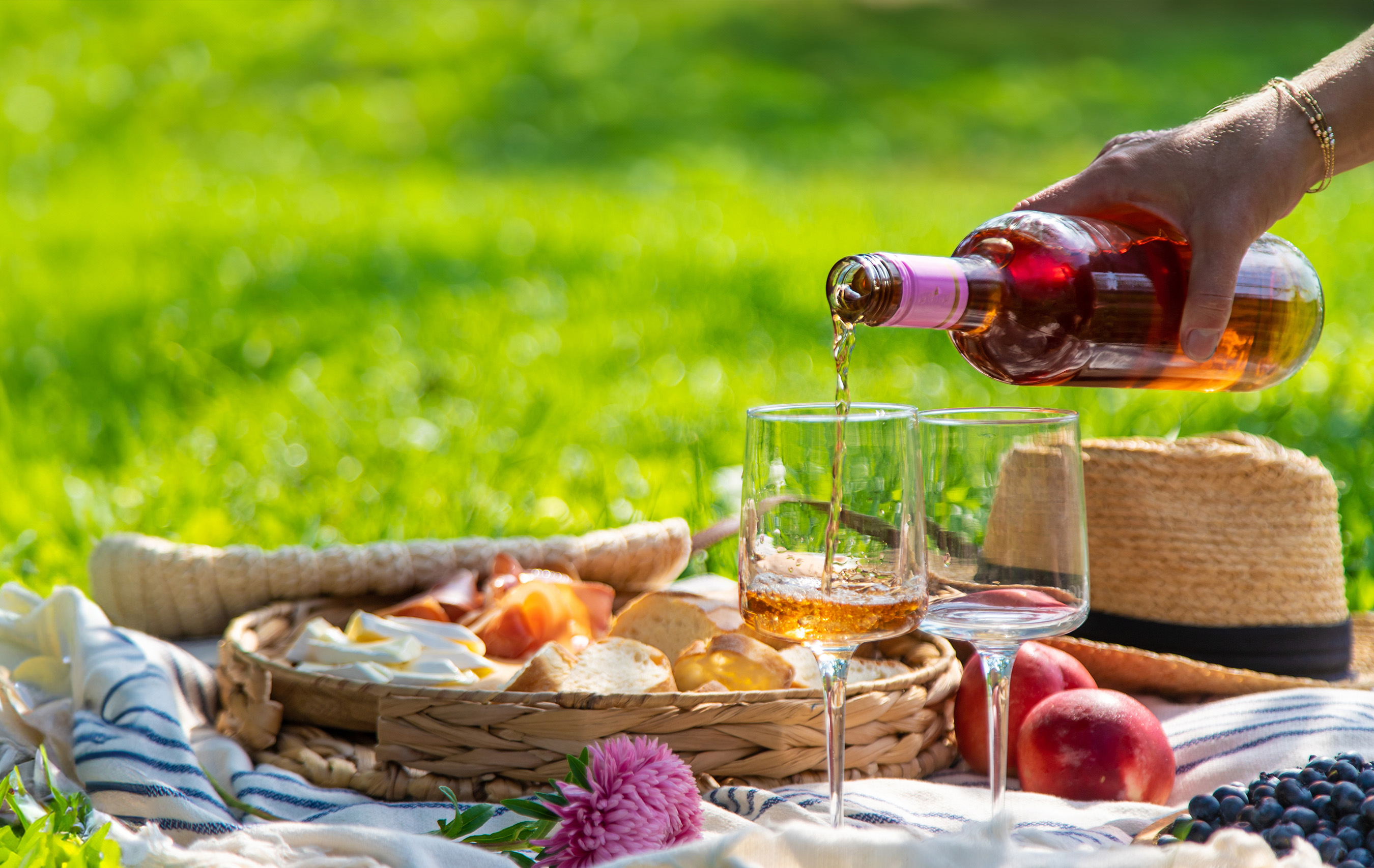 Weißweingläser auf einer Deck im Grünen bereit zum Picknick